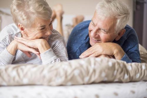 A senior couple relaxing in the home they just purchased using a reverse mortgage.